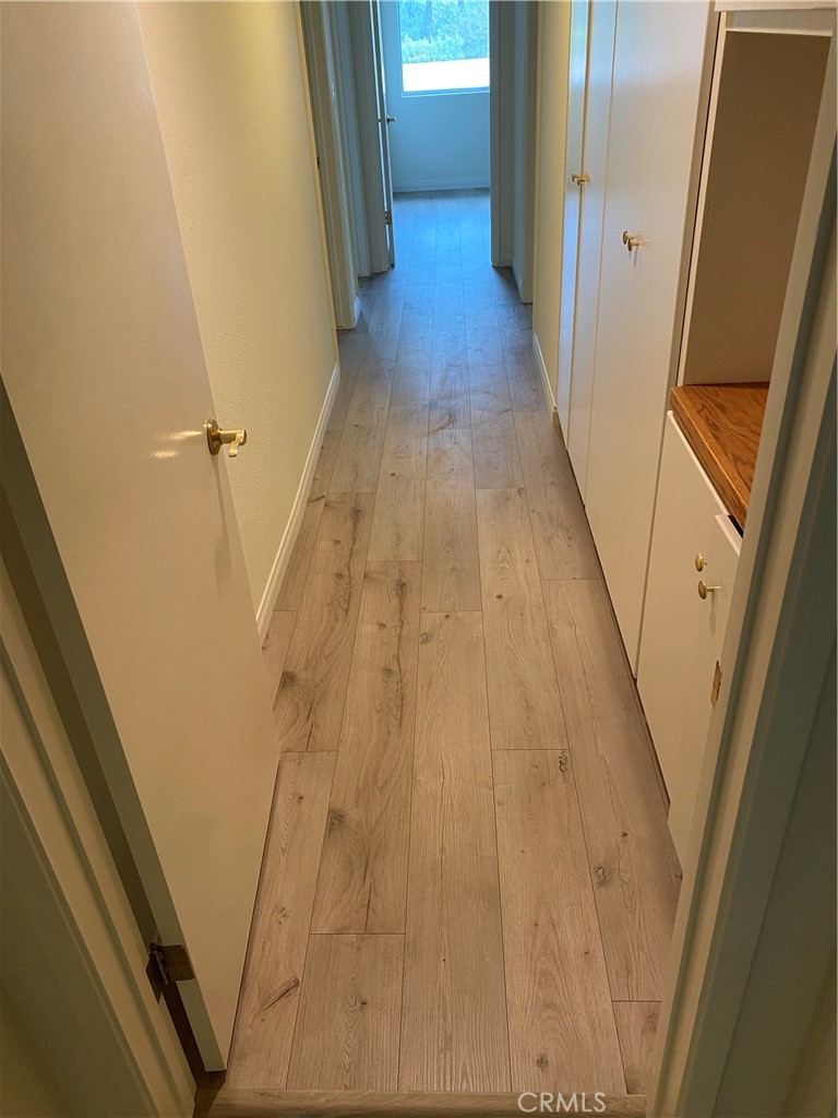 12671 Daryl Avenue Granada Hills, CA 91344 - Photo 8 of 10 a view of a hallway with wooden floor and staircase