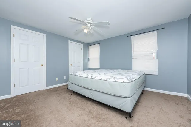 a spacious bedroom with a bed and a chandelier