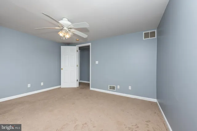 a view of an empty room with a fan