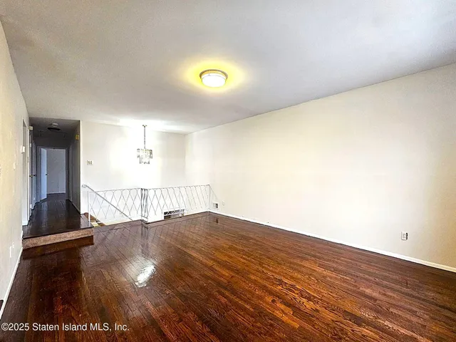 a view of an empty room and wooden floor