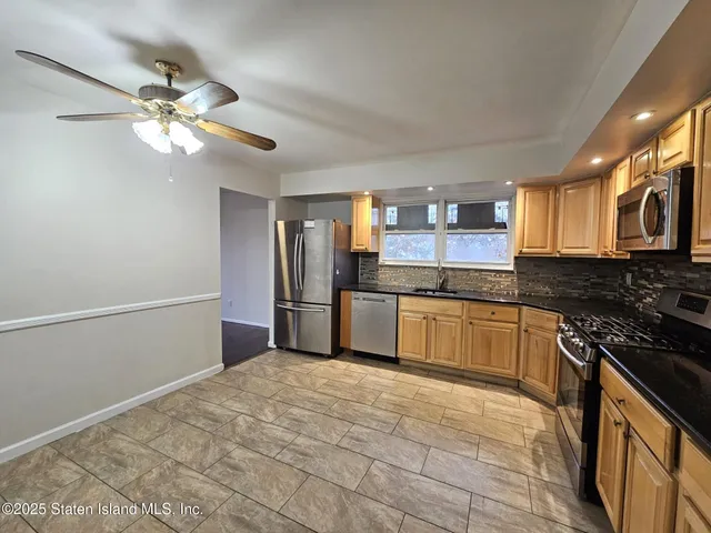 a kitchen with a stove a sink and a refrigerator