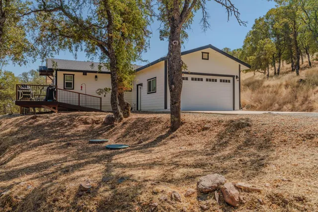 a living room with couches a coffee table and a flat screen tv