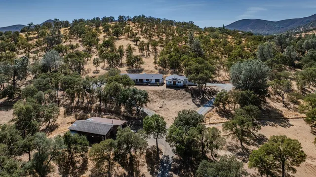 a large kitchen with stainless steel appliances kitchen island granite countertop a refrigerator a stove a sink dishwasher with a dining table and chairs