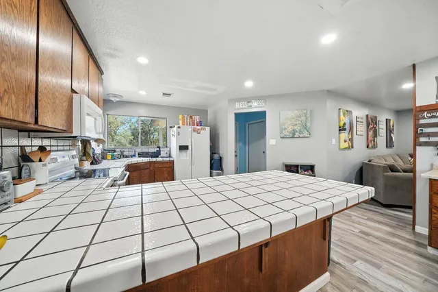 a utility room with stainless steel appliances cabinets and a window