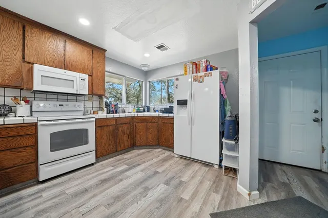 a spacious bedroom with a bed and a large window
