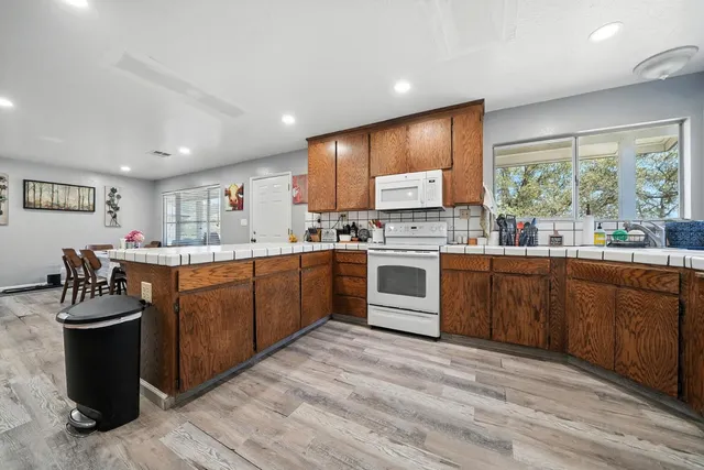 a kitchen with a sink a stove and a refrigerator