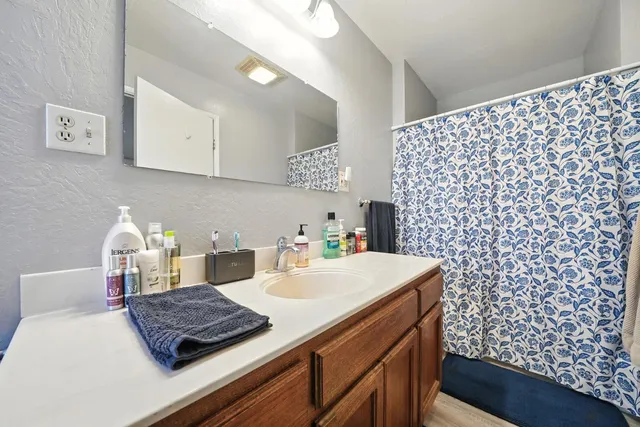 a living room with furniture a rug and a flat screen tv