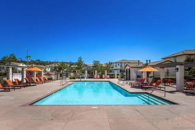 a view of a patio with swimming pool and furniture