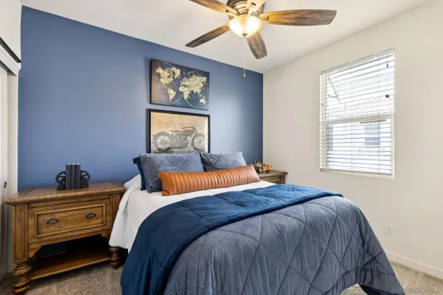 a bedroom with a bed and a chandelier