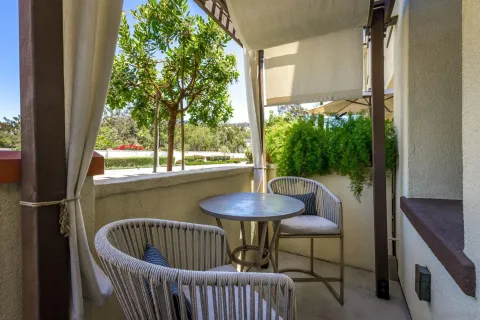 a front view of a house with garden and patio