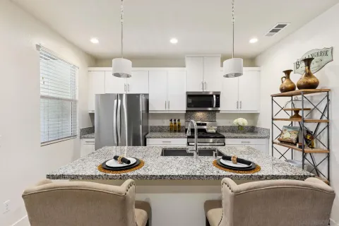 a kitchen with sink refrigerator stove and microwave