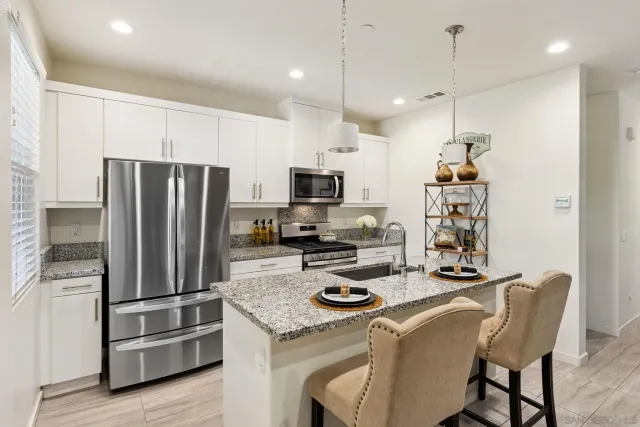 a kitchen with sink refrigerator and microwave