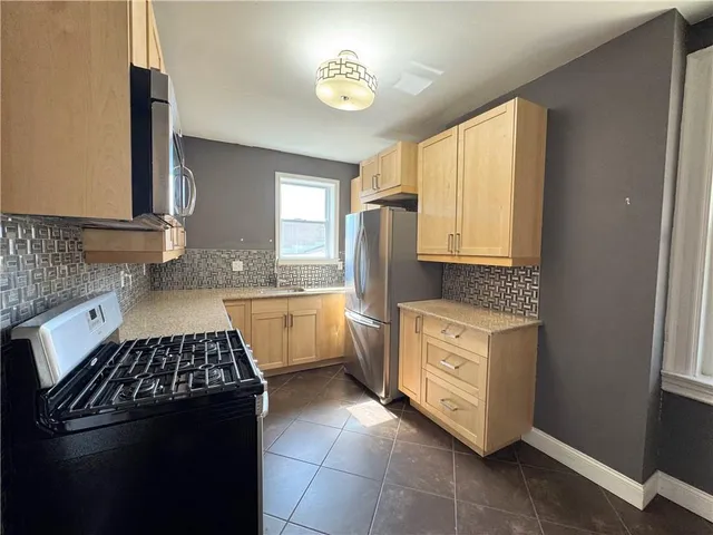 a kitchen with a stove sink and cabinets