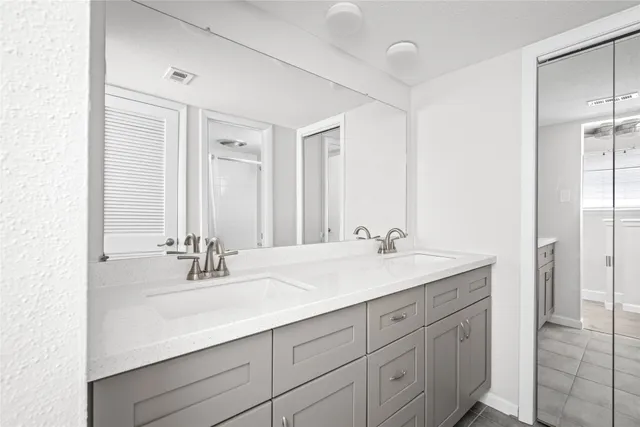 a bathroom with a sink double vanity and a mirror