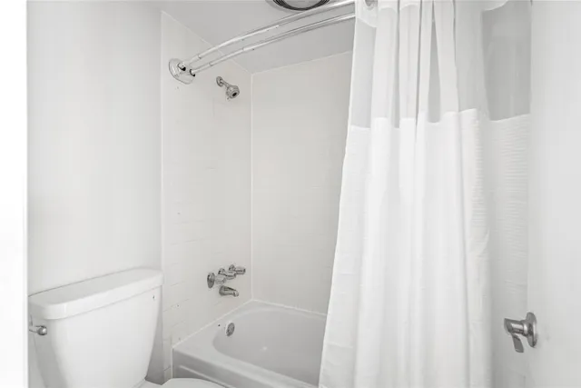 a bathroom with a bathtub and shower