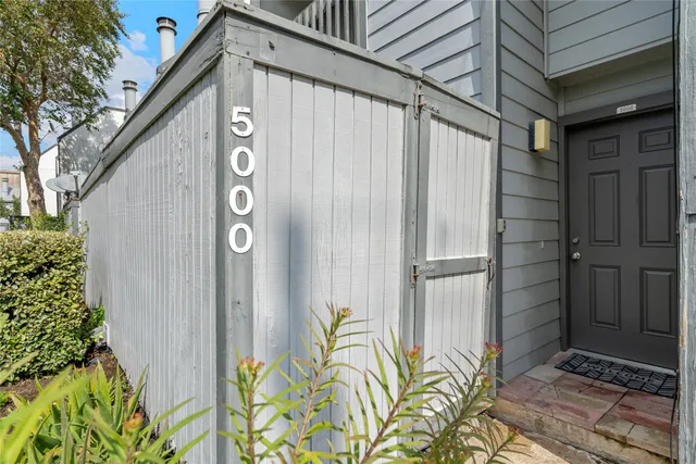 a view of a door and wooden fence