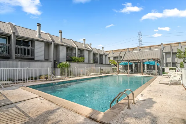 a view of a house with swimming pool and sitting area