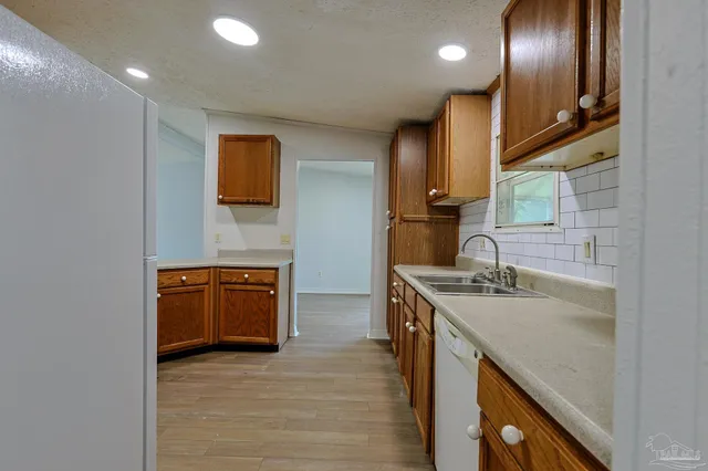a kitchen with stainless steel appliances granite countertop a sink and a stove top oven