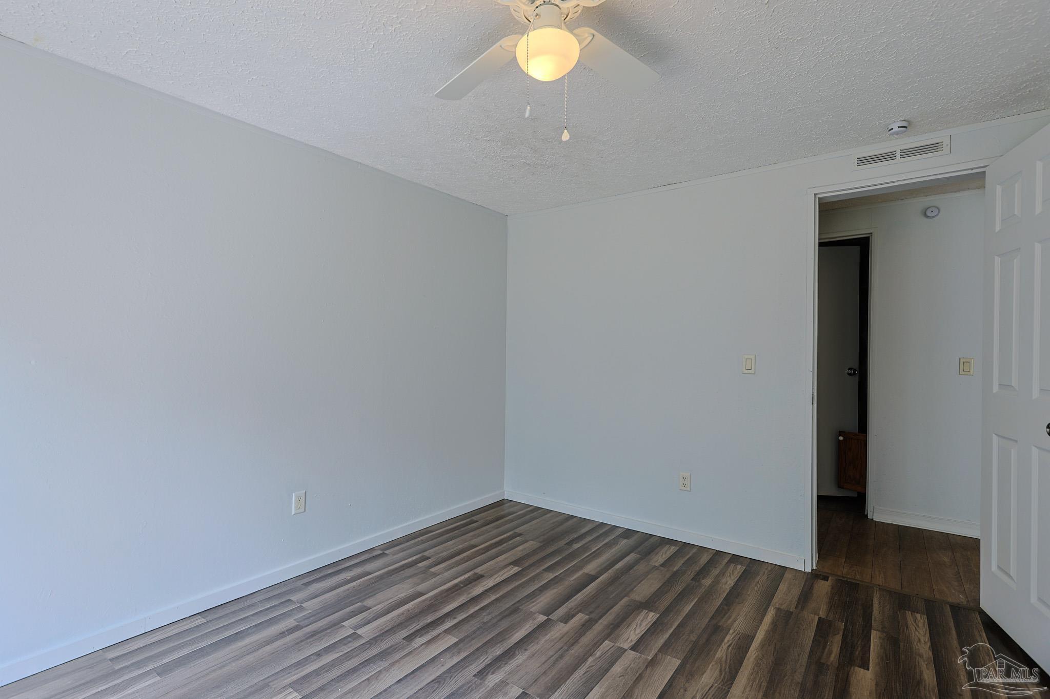 6850 Bratt Road Century, FL 32535 - Photo 30 of 57 a view of an empty room with wooden floor and a window