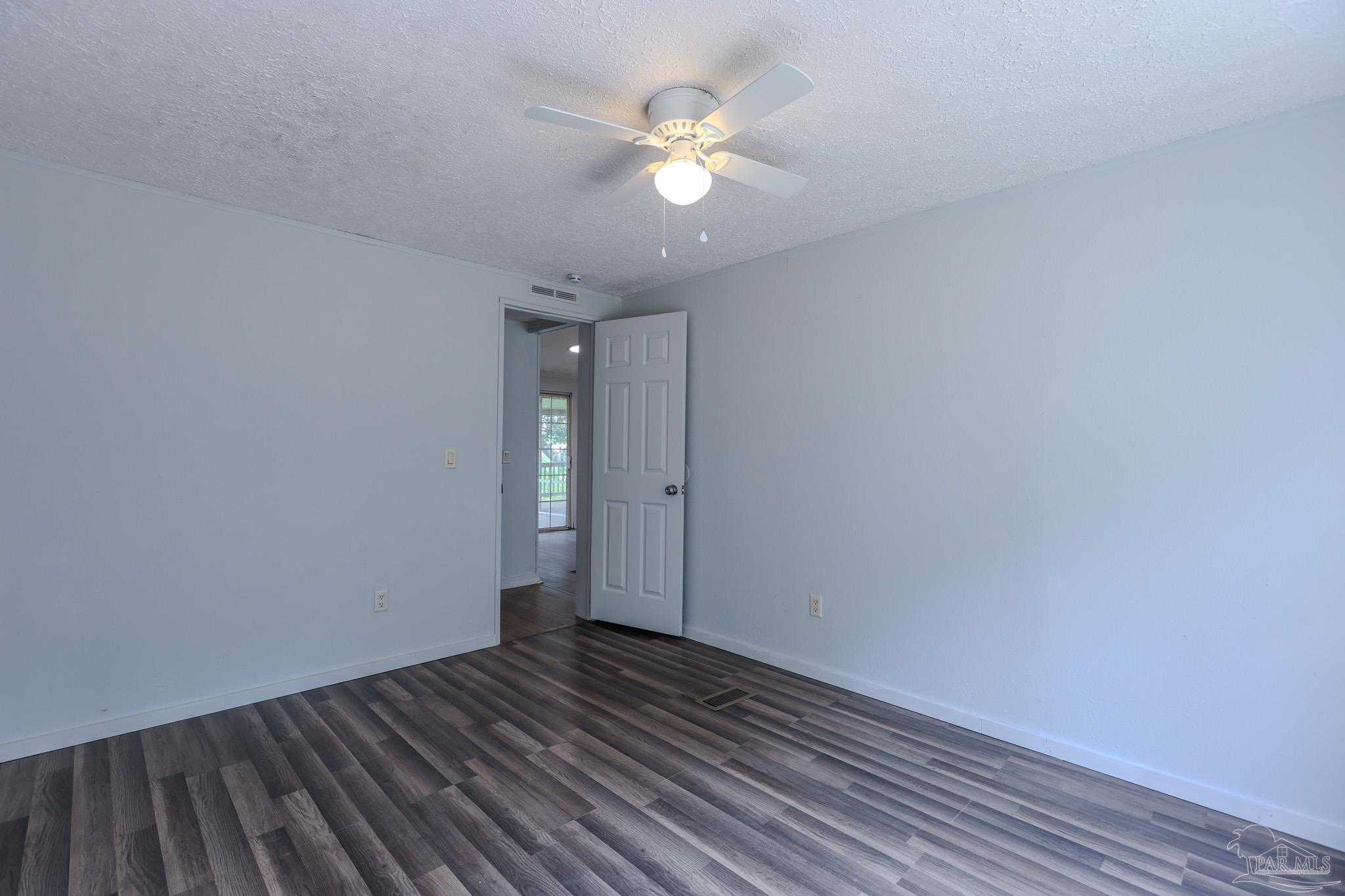 6850 Bratt Road Century, FL 32535 - Photo 31 of 57 a view of an empty room with wooden floor