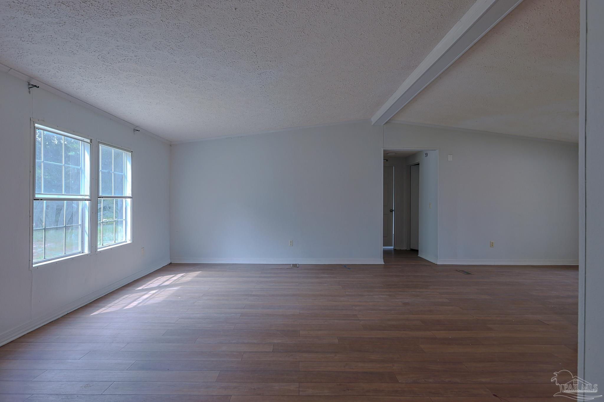 6850 Bratt Road Century, FL 32535 - Photo 34 of 57 a view of an empty room with wooden floor and a window