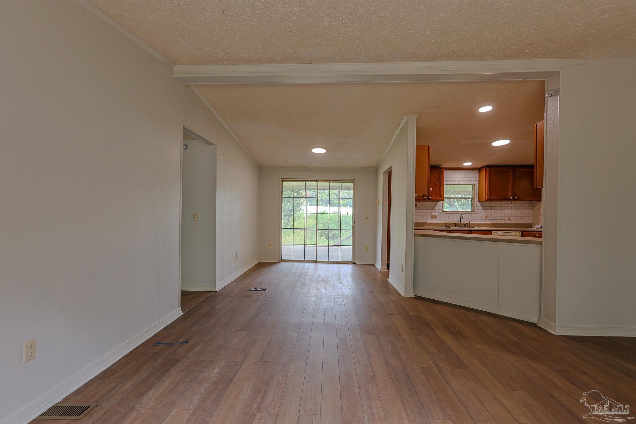 6850 Bratt Road Century, FL 32535 - Photo 36 of 57 a view of hallway with kitchen and wooden floor