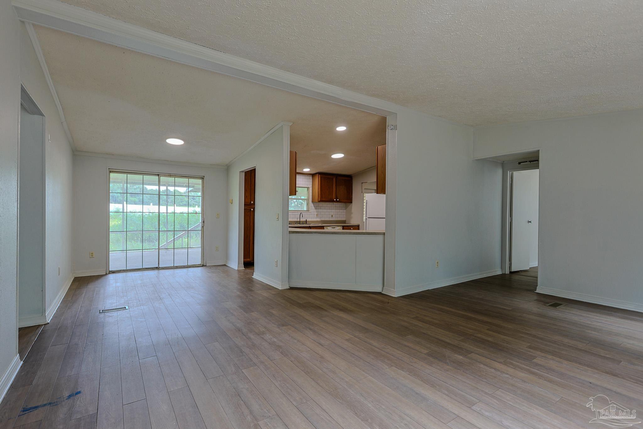 6850 Bratt Road Century, FL 32535 - Photo 37 of 57 a view of a kitchen with wooden floor and a window