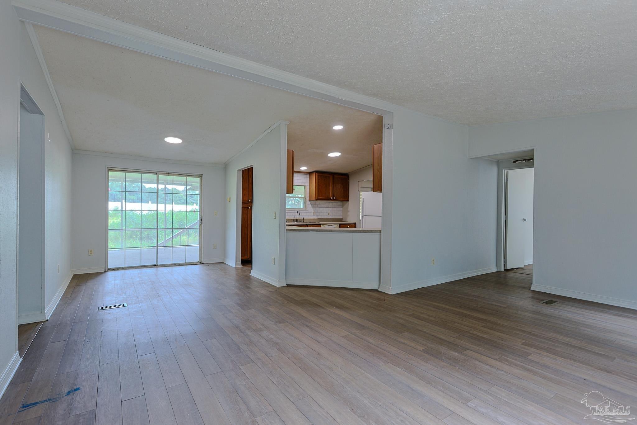 6850 Bratt Road Century, FL 32535 - Photo 38 of 57 a view of a kitchen with wooden floor and a window