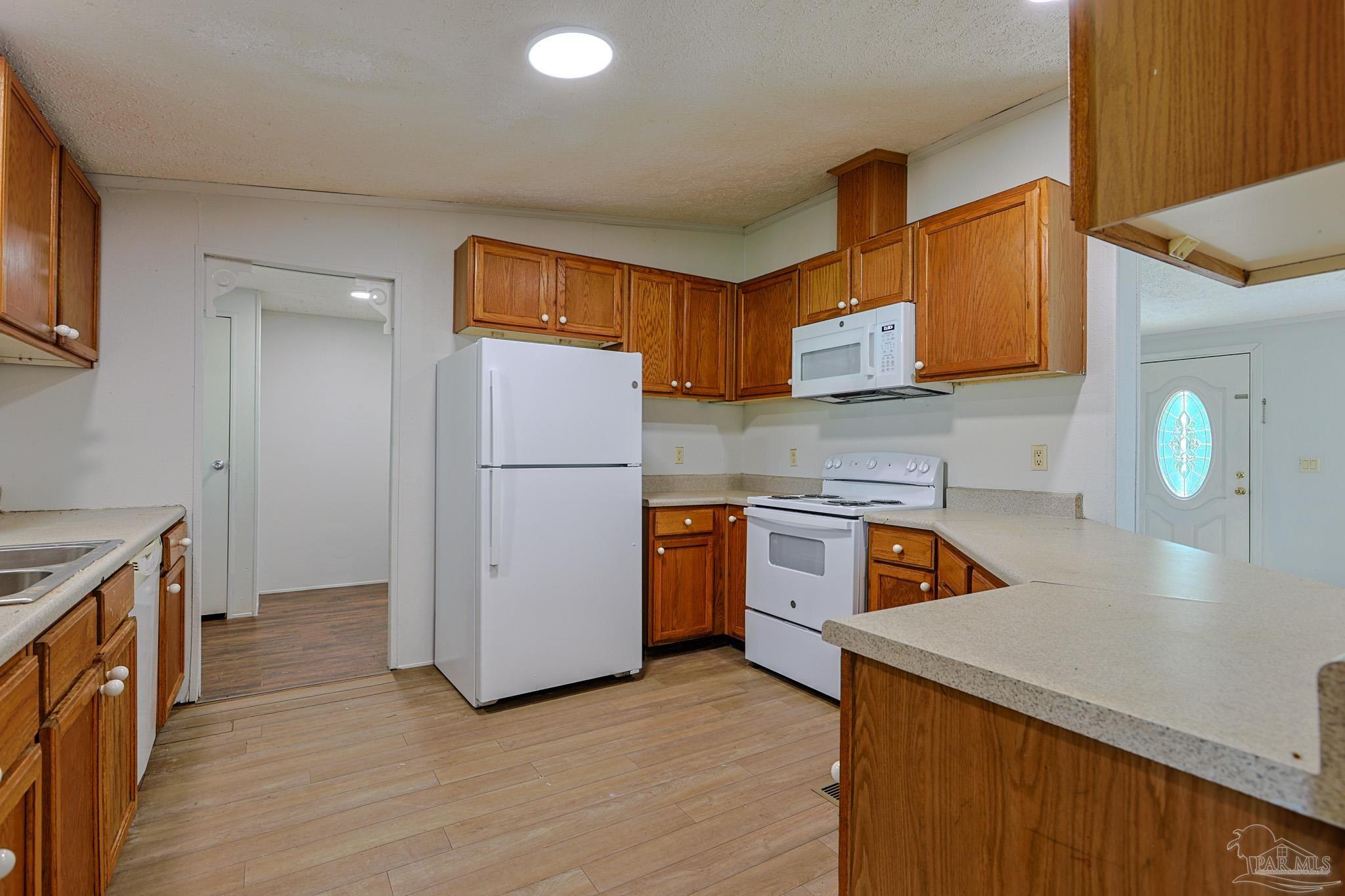 6850 Bratt Road Century, FL 32535 - Photo 40 of 57 a kitchen with refrigerator and cabinets