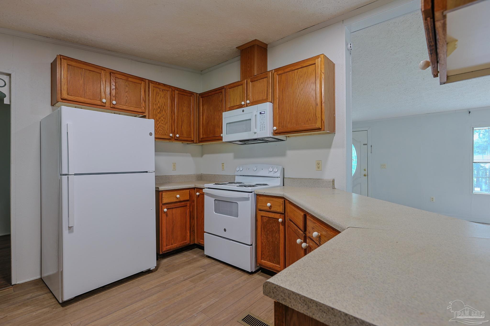6850 Bratt Road Century, FL 32535 - Photo 4 of 57 a kitchen with stainless steel appliances granite countertop a refrigerator a stove a sink and a microwave