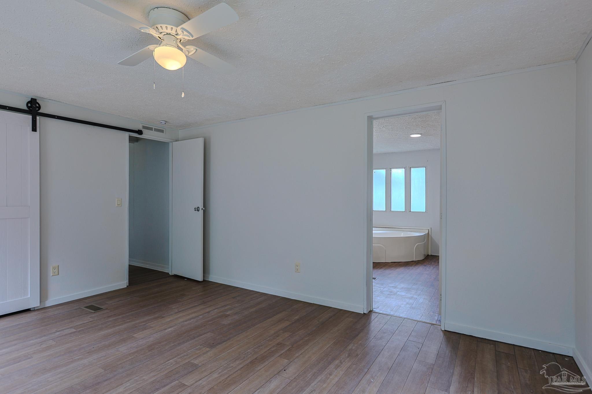 6850 Bratt Road Century, FL 32535 - Photo 43 of 57 a view of a room with wooden floor and windows