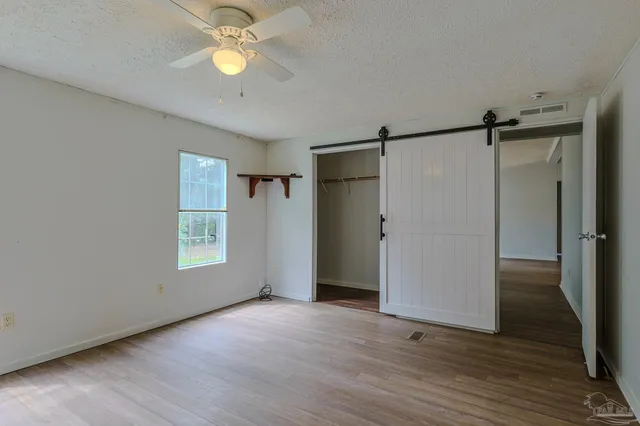 a spacious bathroom with a granite countertop tub and a large mirror