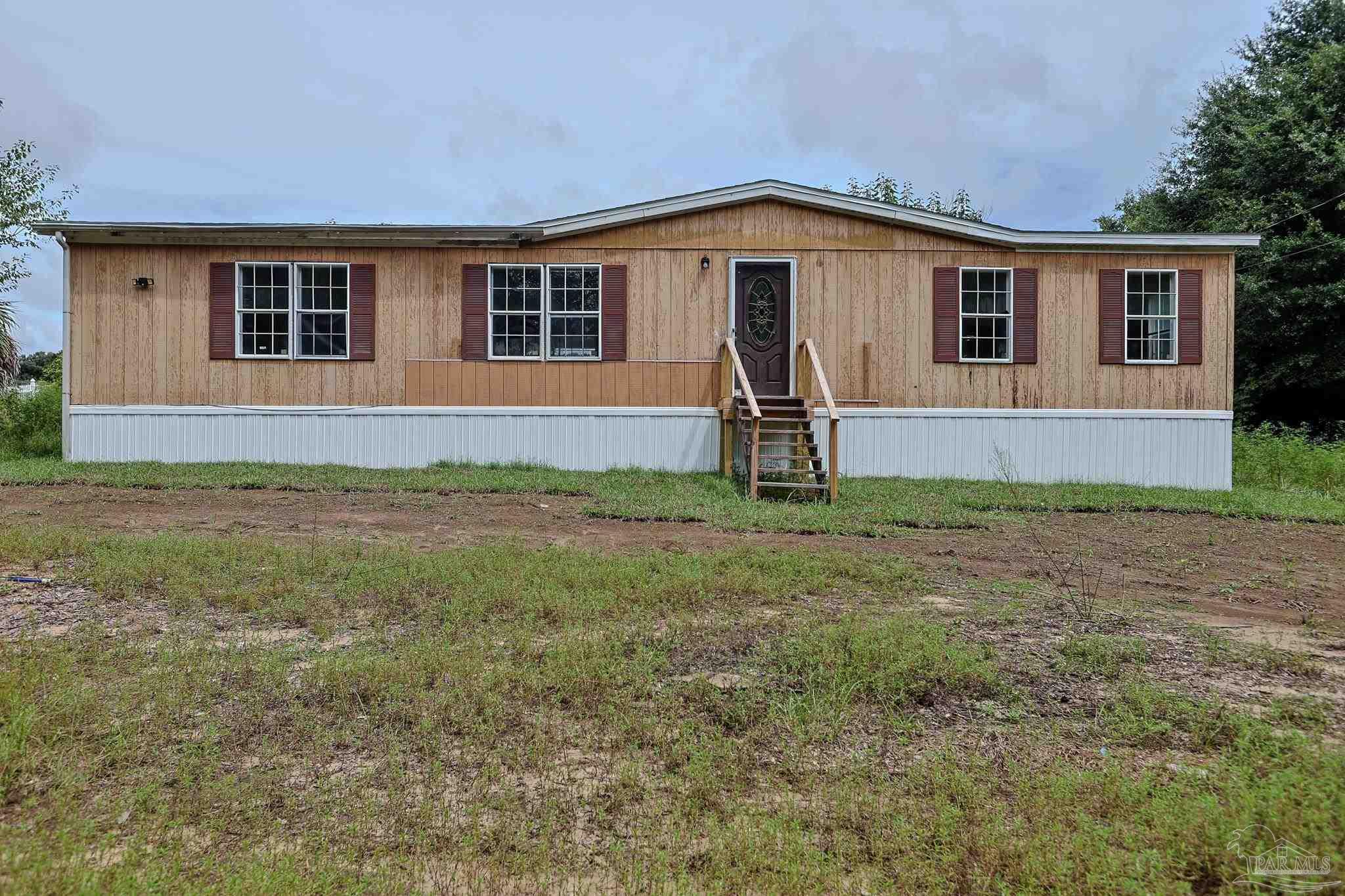 6850 Bratt Road Century, FL 32535 - Photo 54 of 57 a front view of a house with a yard