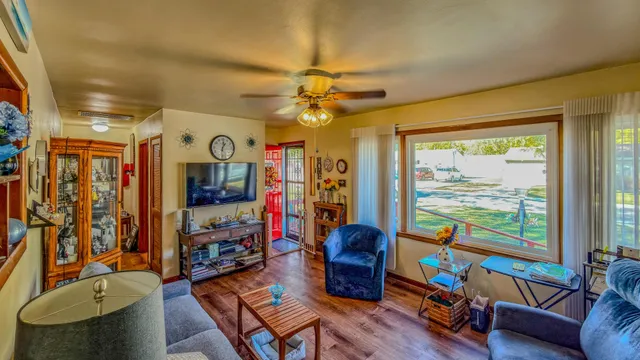 a living room with furniture a flat screen tv and a window