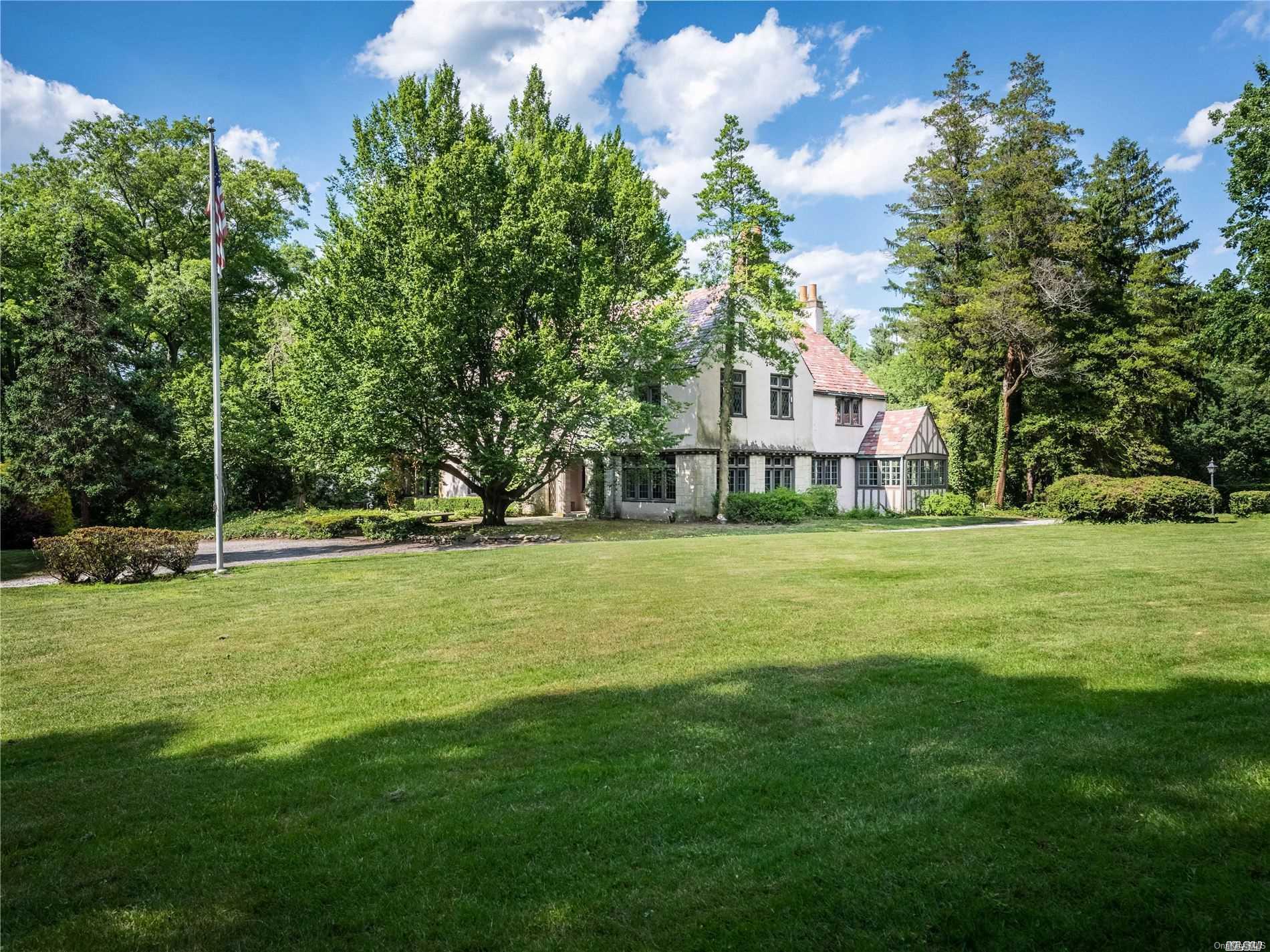 61 South Road Sands Point, NY 11050 - Photo 1 of 1 a front view of a house with a yard