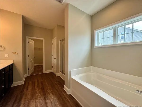 a bathroom with a bathtub and a shower
