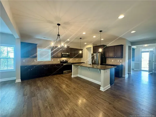 a kitchen with stainless steel appliances kitchen island a refrigerator and a stove