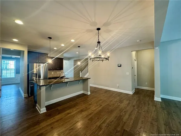 an open kitchen with a table and chairs