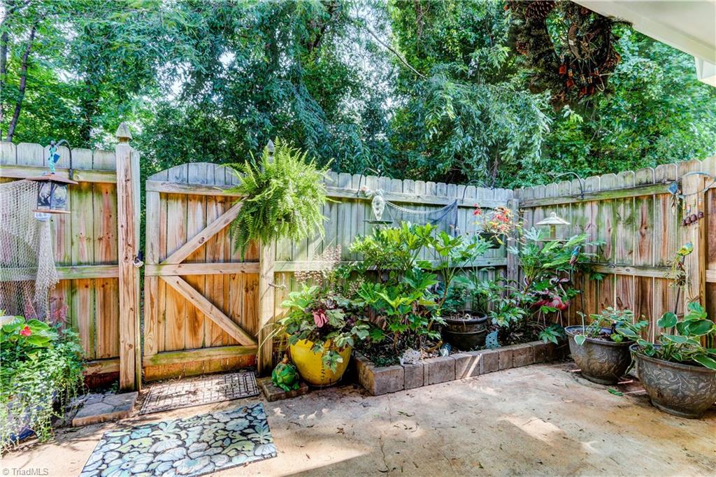 4932 Tower Road, Unit A Greensboro, NC 27410 - Photo 22 of 24 Patio with Privacy Fence