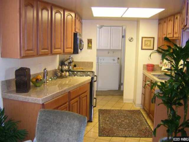 3990 Covington Way, Unit A Reno, NV 89503 - Photo 4 of 9 a kitchen with stainless steel appliances granite countertop a sink a stove and a refrigerator