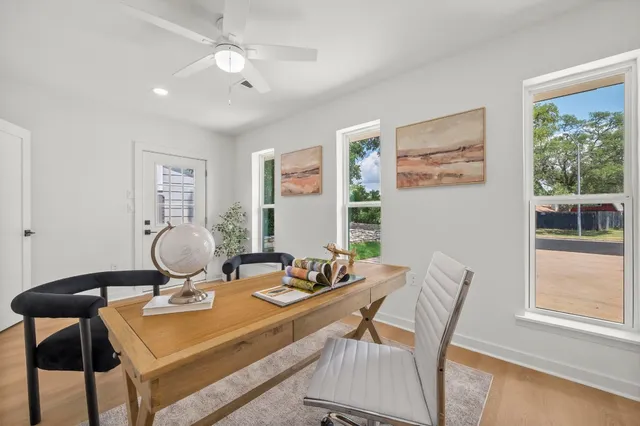a view of a workspace with furniture and window