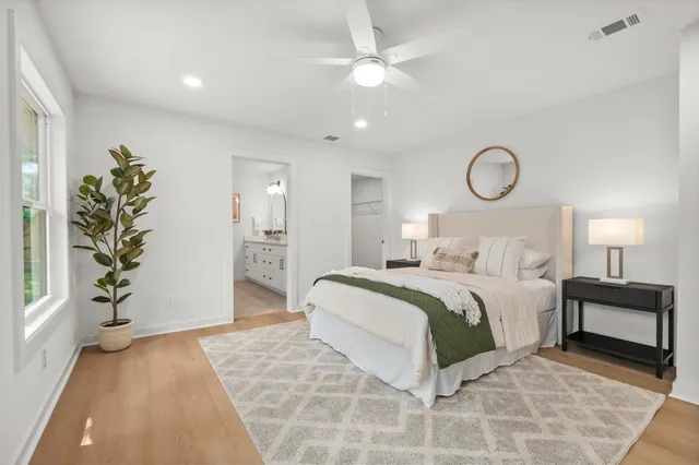 a bedroom with a large bed and a chandelier