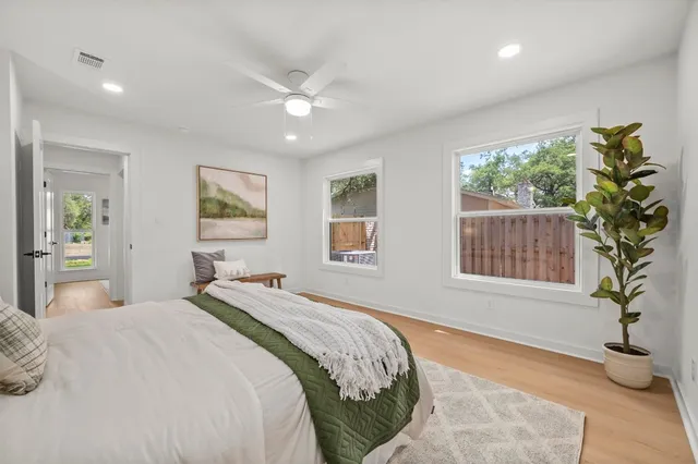 a bedroom with a large bed and a window