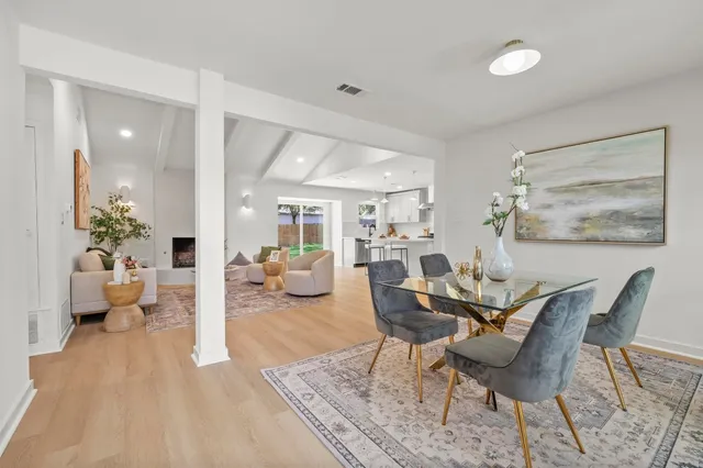a dining room with furniture and wooden floor