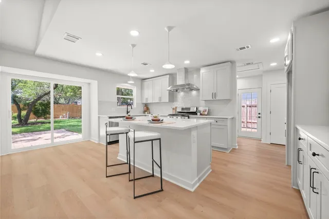 a kitchen with a sink cabinets and window