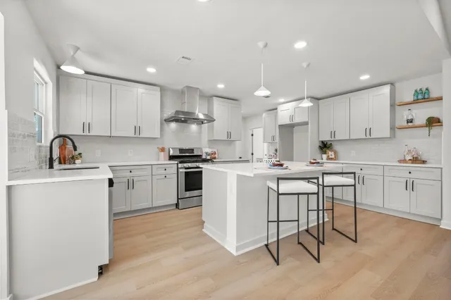 a kitchen with a sink cabinets and white stainless steel appliances