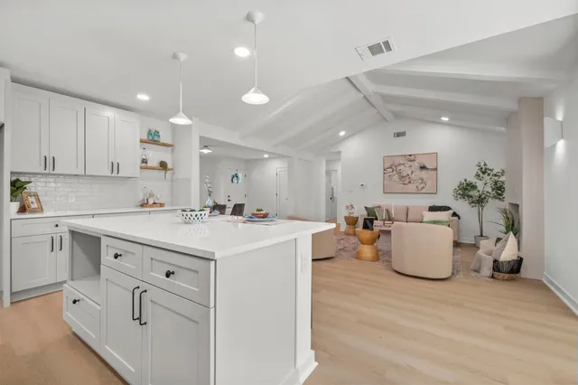 a kitchen with kitchen island white cabinets and counter space