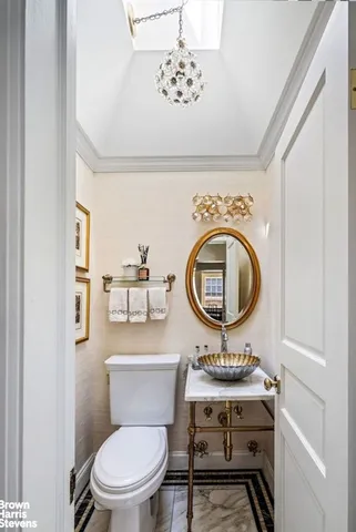 a bathroom with a toilet a sink and a mirror