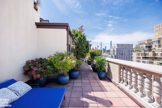 a view of a bunch of flower plants in front of a building