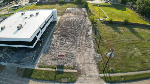 an aerial view of a residential houses with outdoor space